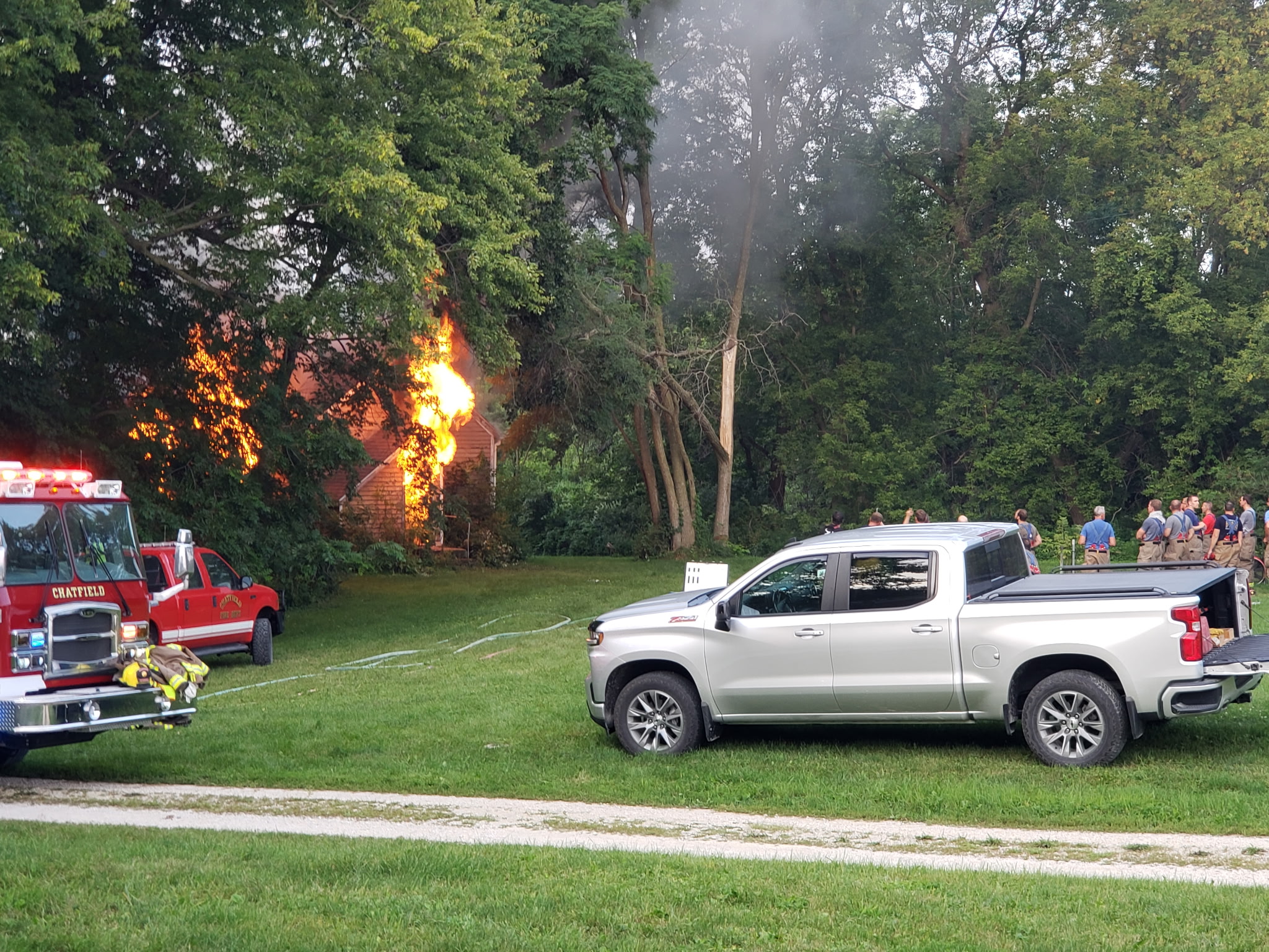 Before: House actively burning with fire department on scene