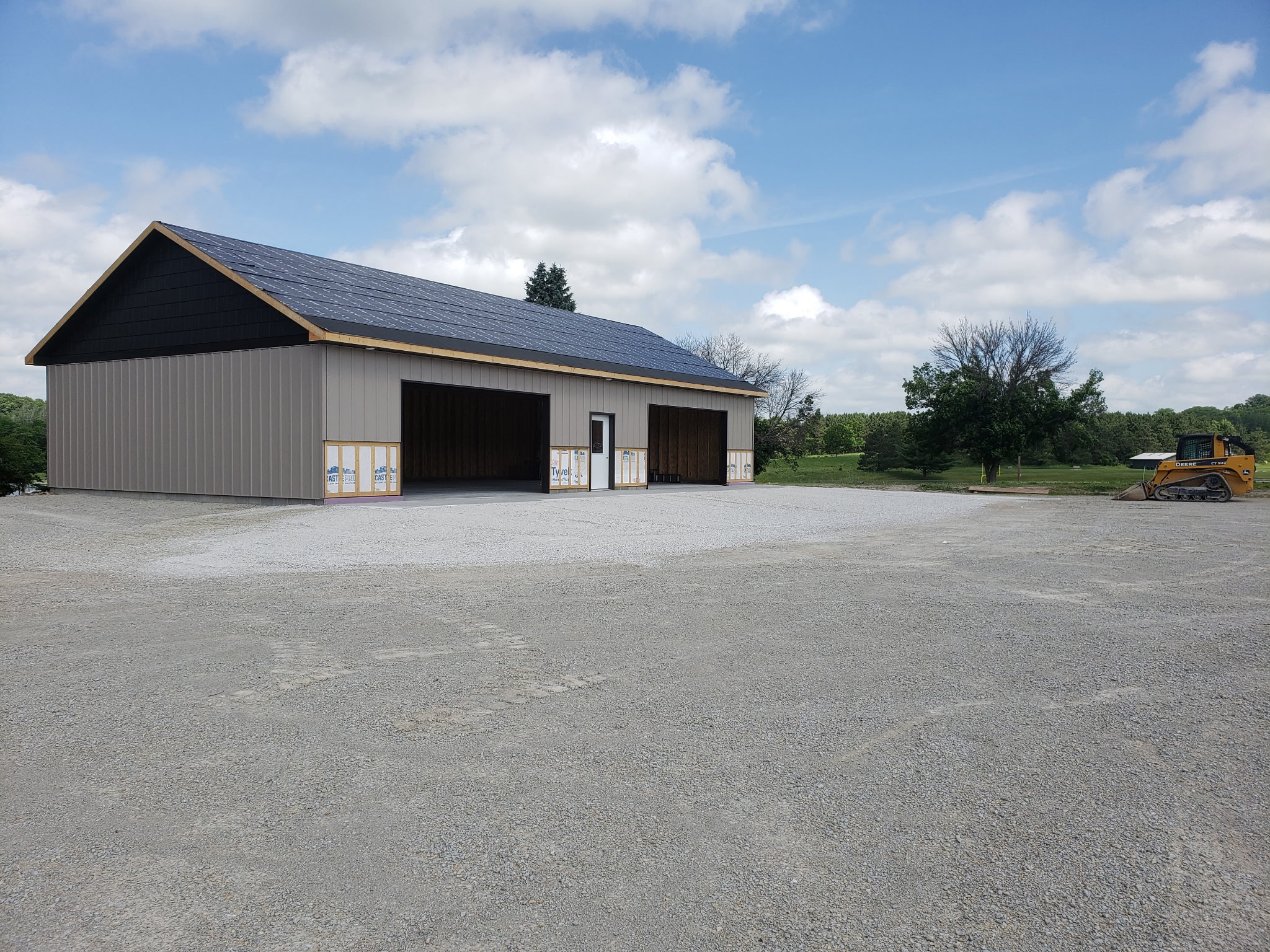 After: Completed garage with finished gravel driveway