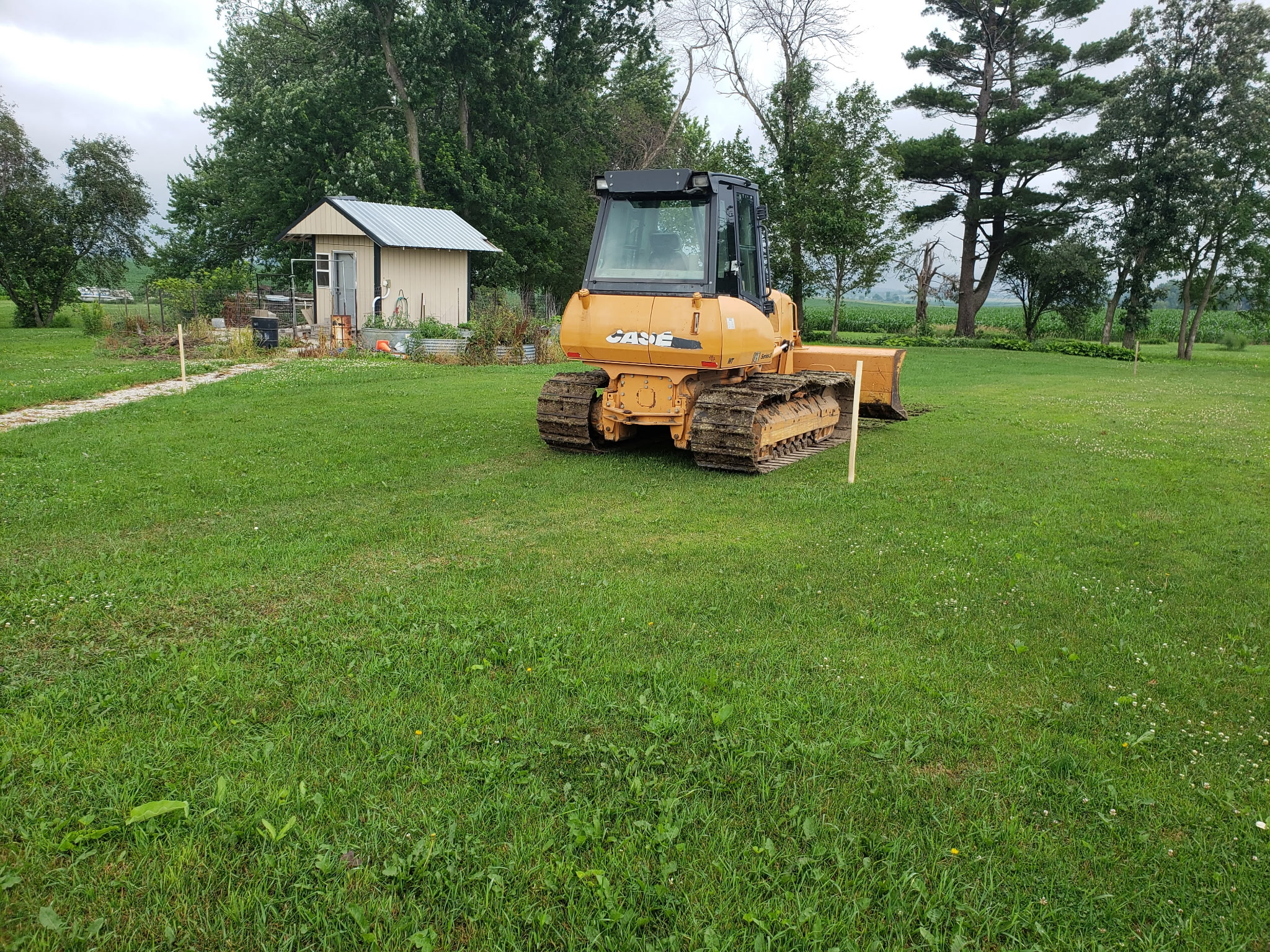 Before: Initial site preparation with bulldozer marking out the area